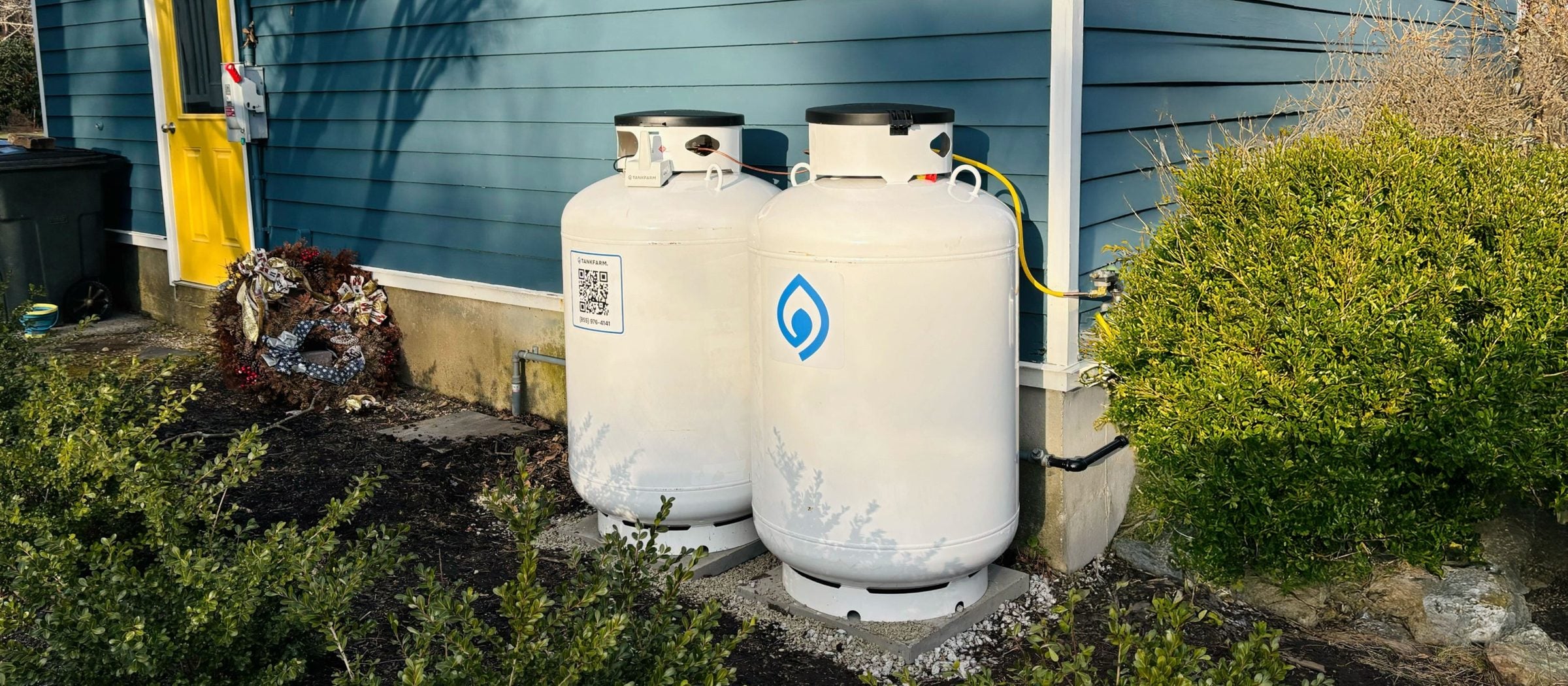 Two Tankfarm propane tanks installed beside a home